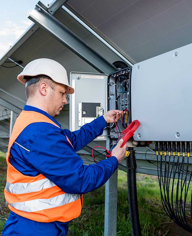 Solar Installer Connecting Inverter To Solar Panels